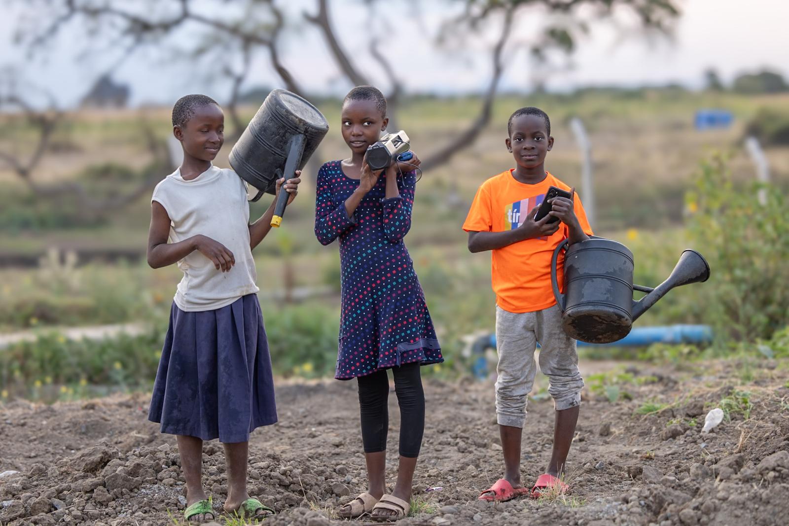 Girls watering the vegetable gardens